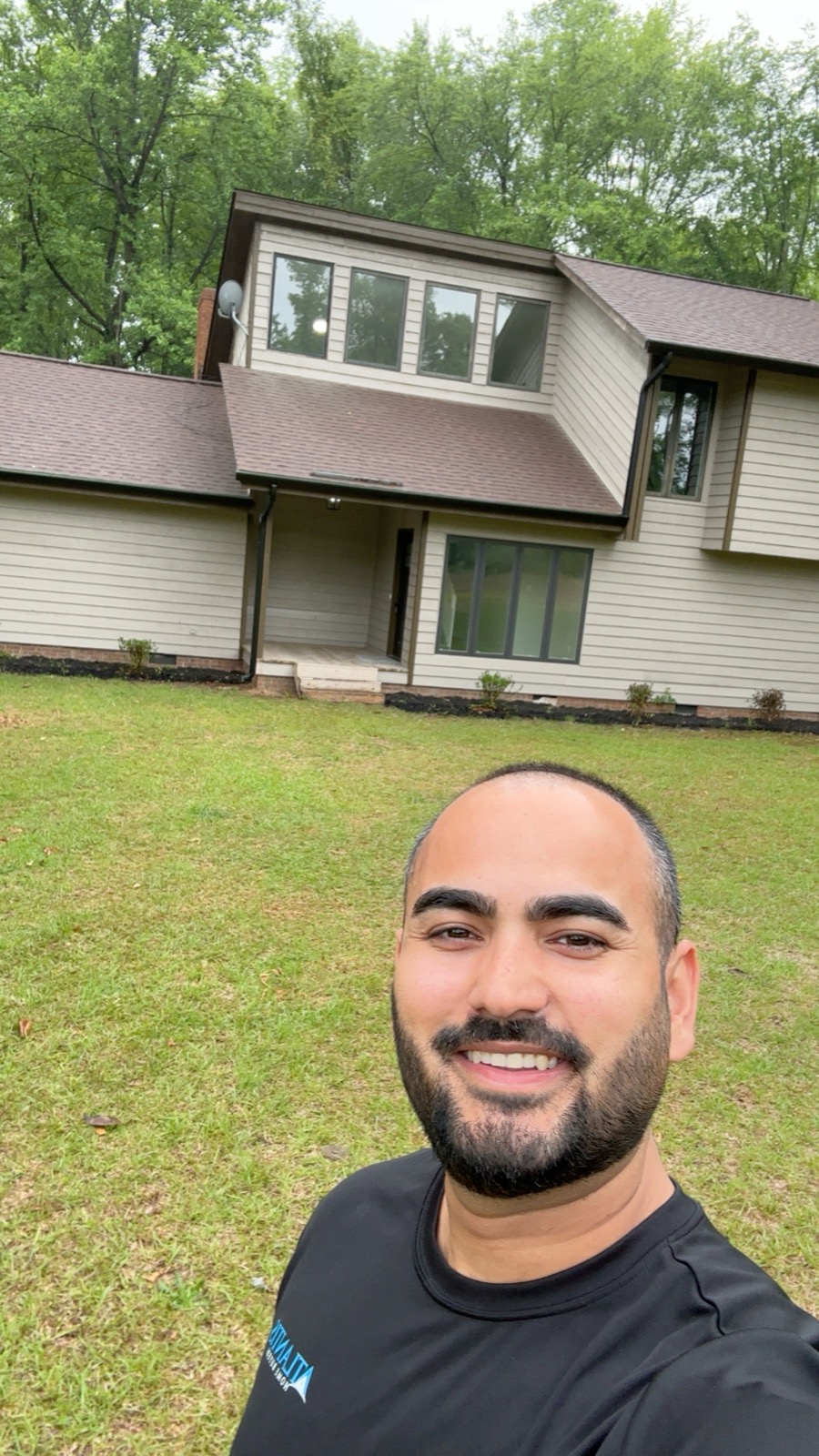AJ Jamal founder of Atlantis Homebuyers walking a recently purchased NC property on-site