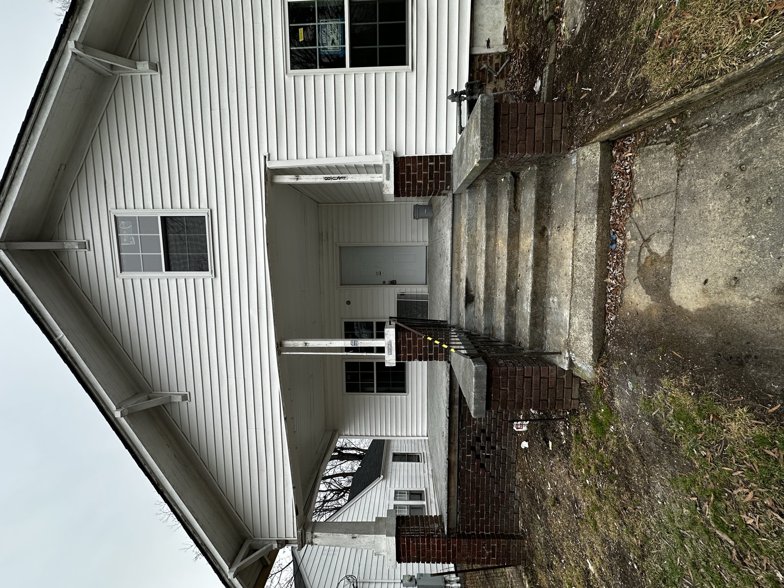 Distressed exterior of an NC rental property with deferred maintenance bought as-is by Atlantis Homebuyers